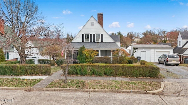 view of front of property with driveway and a chimney