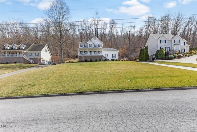 view of front of property with stairs and a front yard