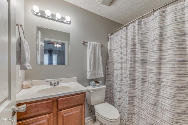 full bath featuring vanity, toilet, and a textured ceiling