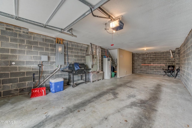 garage with concrete block wall, electric panel, a garage door opener, and water heater