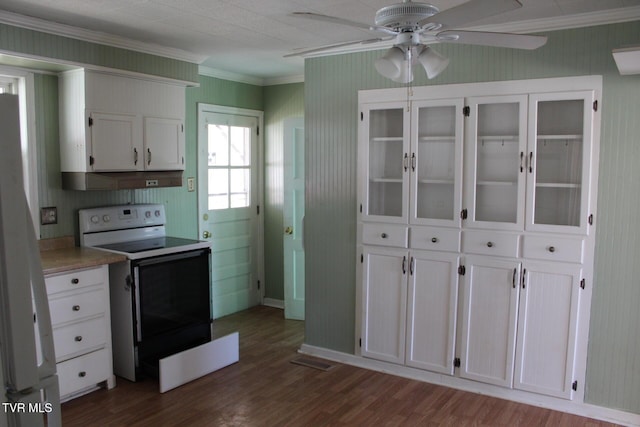 kitchen featuring white cabinets, electric stove, dark wood-type flooring, and ornamental molding