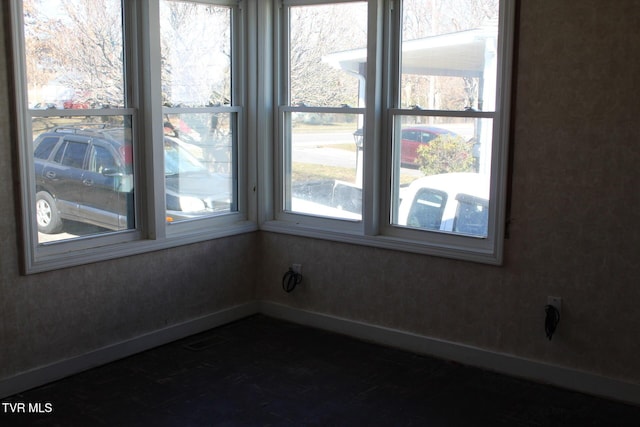 empty room featuring baseboards