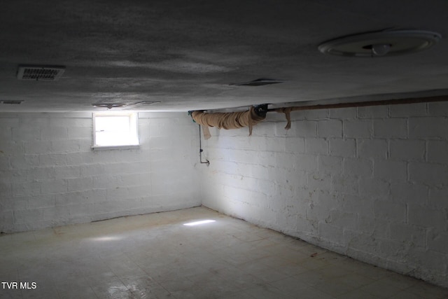 basement featuring tile patterned floors and visible vents