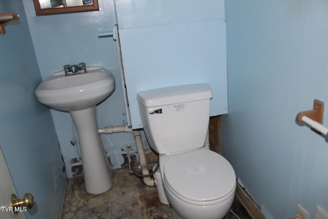 bathroom with toilet and concrete floors