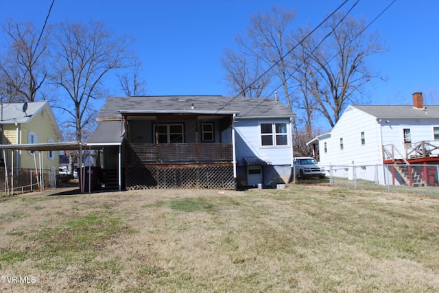 back of house featuring a lawn and fence