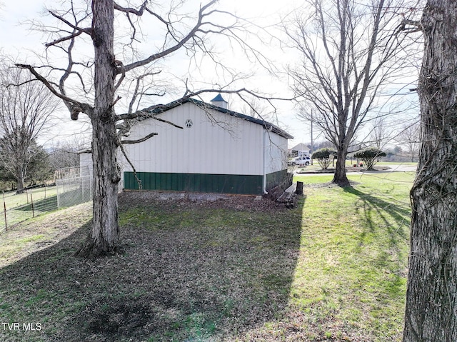 view of yard featuring an outbuilding, an outdoor structure, and fence