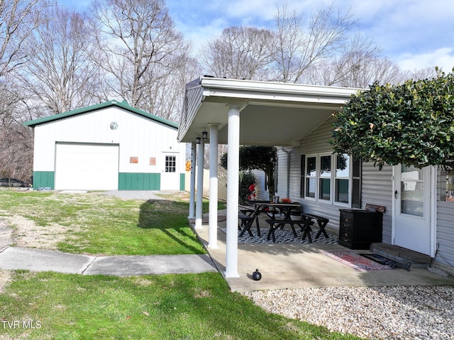 view of patio featuring a garage and an outbuilding