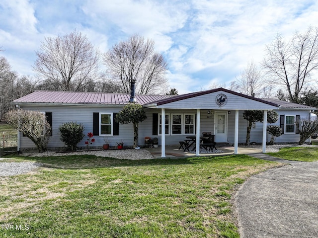 ranch-style home with metal roof and a front lawn