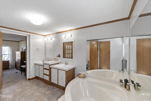 full bath featuring crown molding, a bathtub, ensuite bath, a textured ceiling, and vanity