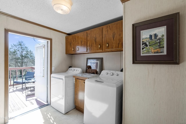 laundry area with crown molding, washer and clothes dryer, light floors, cabinet space, and a textured ceiling