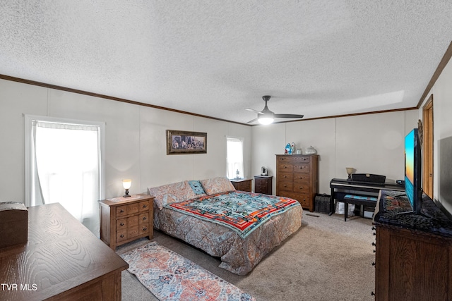 bedroom with ornamental molding, a textured ceiling, ceiling fan, and carpet floors