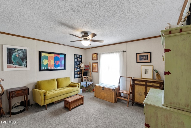 living area featuring ceiling fan, crown molding, carpet floors, and a textured ceiling