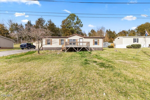 manufactured / mobile home with a front yard, crawl space, aphalt driveway, and a wooden deck