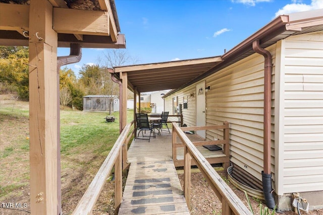 wooden deck featuring a lawn