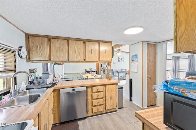 kitchen with dishwasher, light wood-style floors, a textured ceiling, a ceiling fan, and a sink