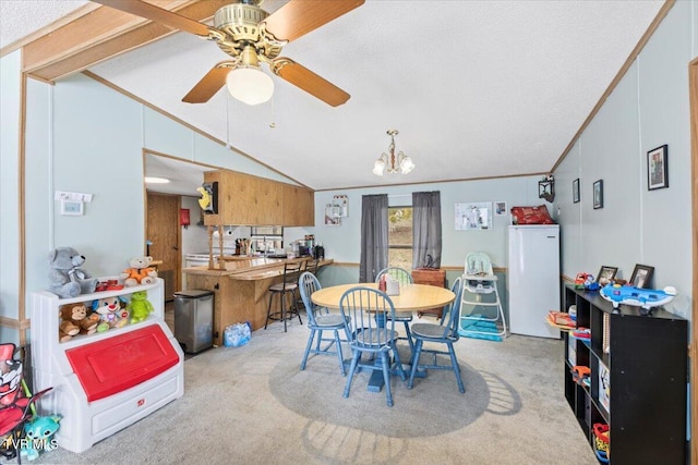 carpeted dining room featuring vaulted ceiling, ceiling fan with notable chandelier, and ornamental molding