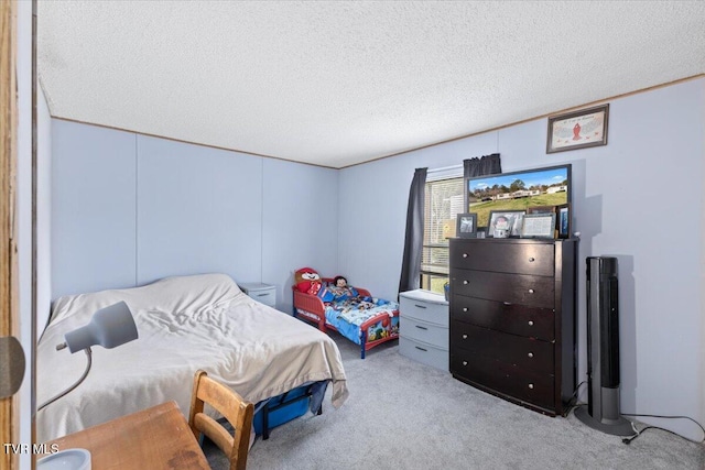 carpeted bedroom featuring a textured ceiling