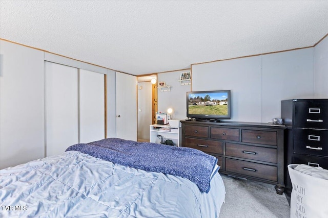 bedroom featuring light colored carpet and a textured ceiling