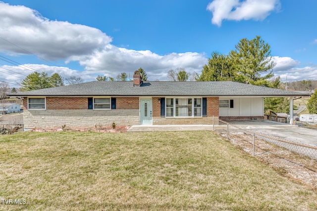 ranch-style home with brick siding, an attached carport, and a front yard