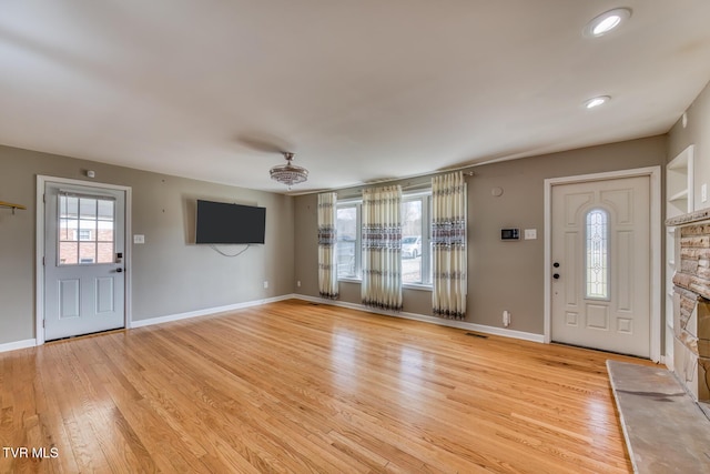 entrance foyer featuring light wood-type flooring, baseboards, and visible vents