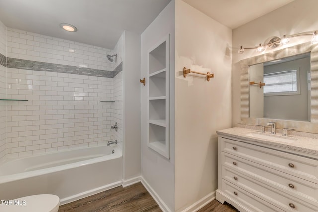 full bathroom featuring baseboards, toilet, shower / tub combination, wood finished floors, and vanity