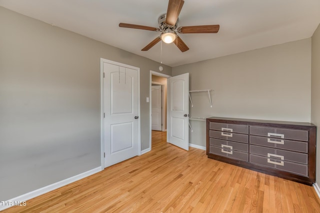 unfurnished bedroom with ceiling fan, baseboards, and wood finished floors