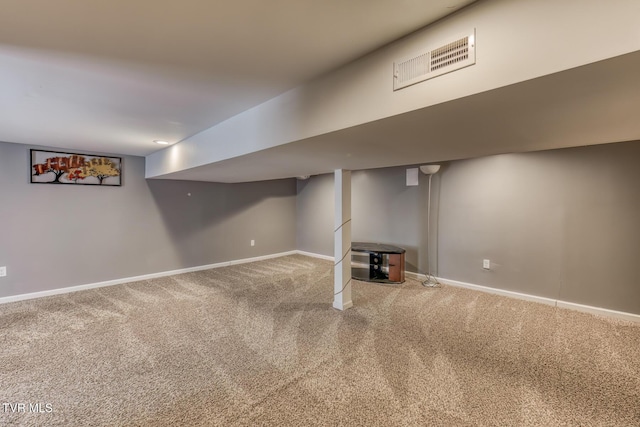 finished basement with carpet flooring, baseboards, and visible vents