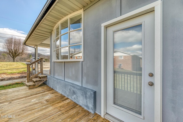 view of exterior entry featuring stucco siding