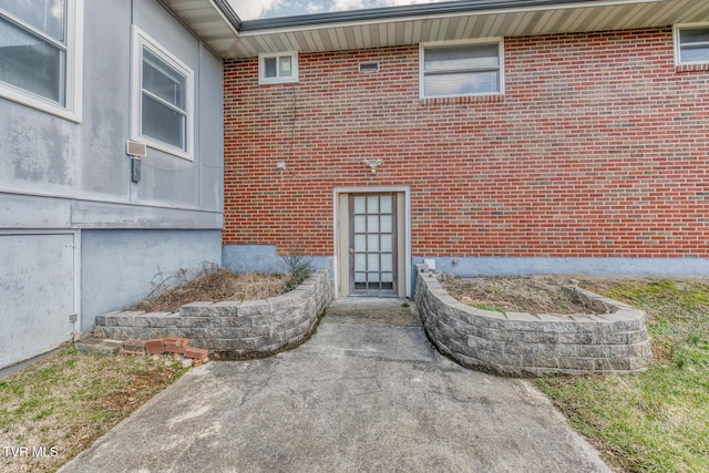 property entrance featuring brick siding