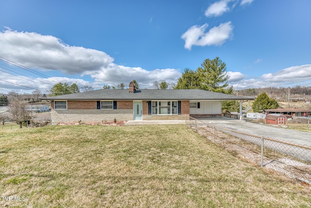 ranch-style house featuring a carport, brick siding, a front lawn, and driveway