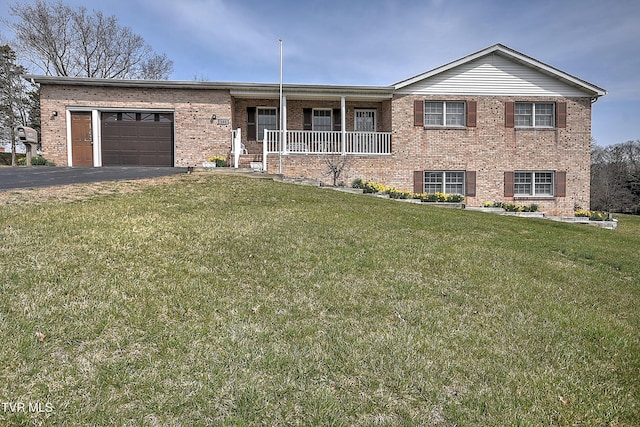 ranch-style home featuring a front lawn, aphalt driveway, a porch, a garage, and brick siding