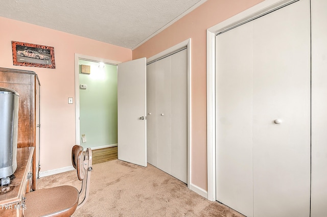 carpeted home office with baseboards and a textured ceiling