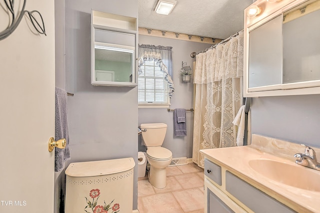 full bath featuring toilet, a textured ceiling, vanity, and baseboards