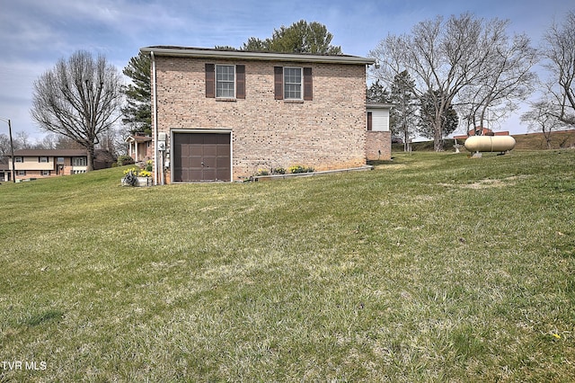 view of side of property featuring brick siding, a lawn, and a garage