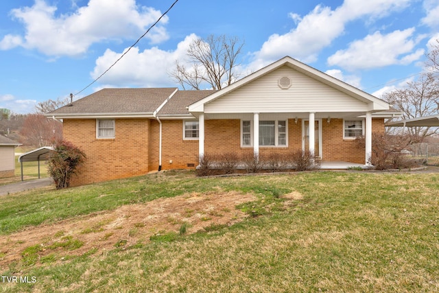 ranch-style home featuring brick siding, covered porch, a front yard, and roof with shingles