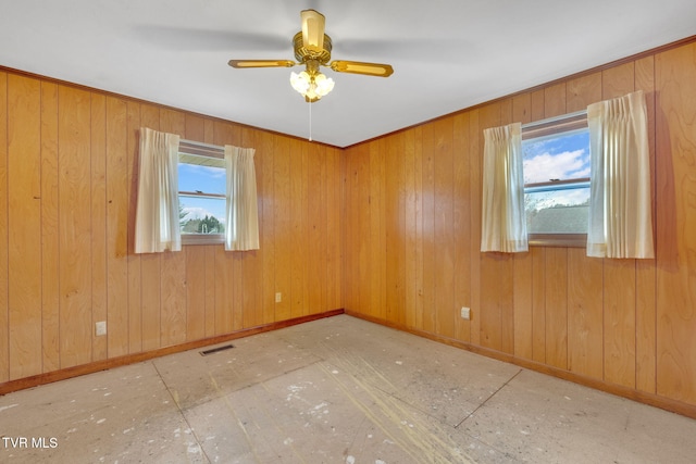 empty room featuring a ceiling fan, baseboards, and visible vents