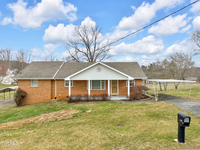 view of front of home with brick siding, covered porch, a front lawn, and roof with shingles