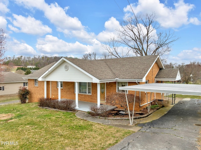 ranch-style home featuring brick siding, a porch, a shingled roof, and a front yard