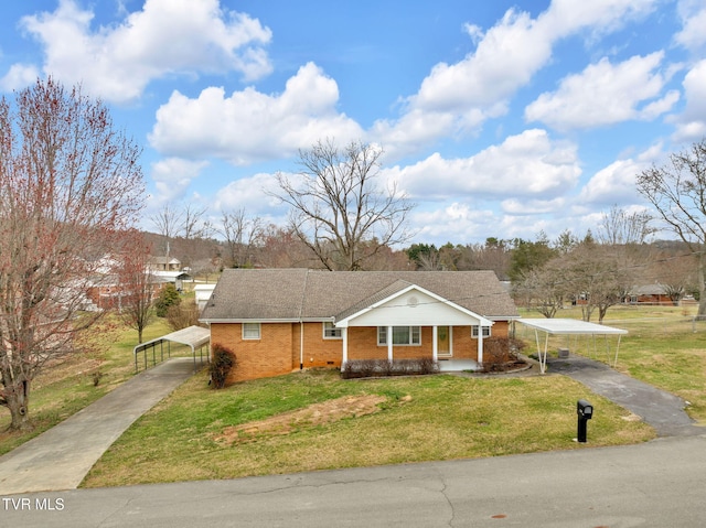 view of front facade with a detached carport, aphalt driveway, brick siding, and a front yard