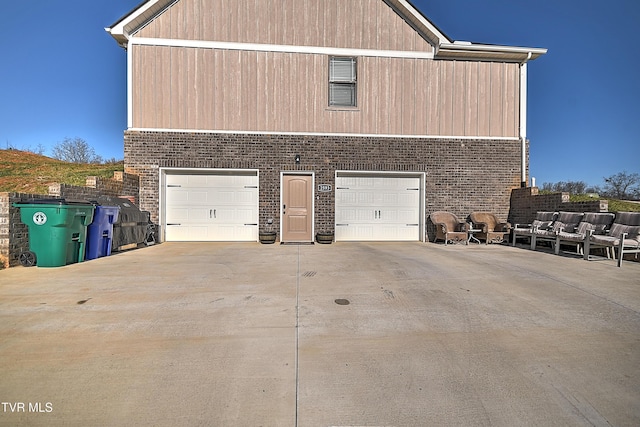 garage featuring concrete driveway