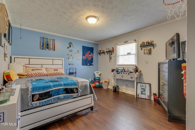 bedroom featuring baseboards, a textured ceiling, wood finished floors, and ornamental molding