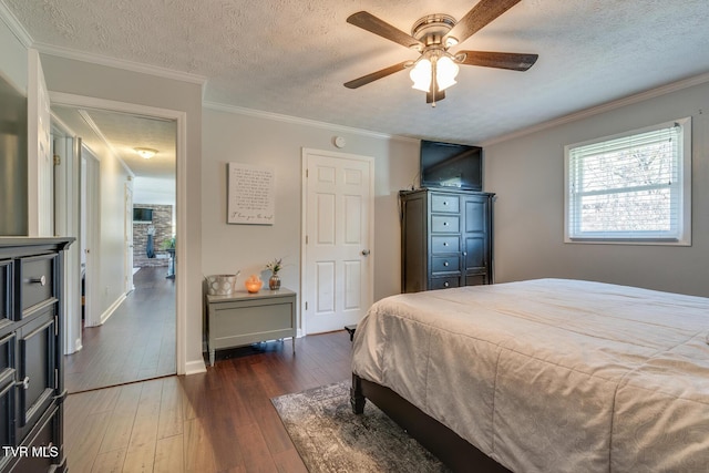 bedroom with a textured ceiling, crown molding, a ceiling fan, and hardwood / wood-style flooring