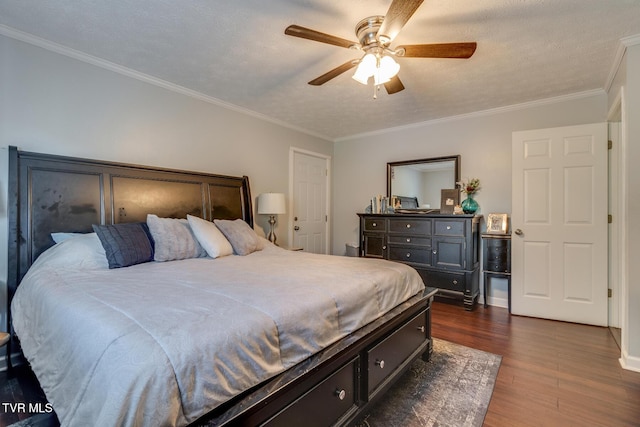 bedroom featuring ceiling fan, dark wood-type flooring, ornamental molding, and a textured ceiling