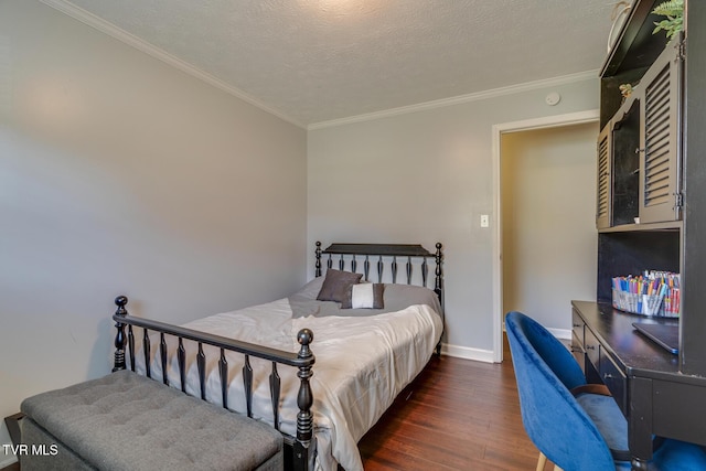 bedroom featuring baseboards, a textured ceiling, wood finished floors, and crown molding