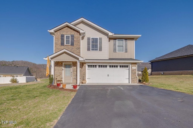 view of front of property with brick siding, driveway, an attached garage, and a front lawn