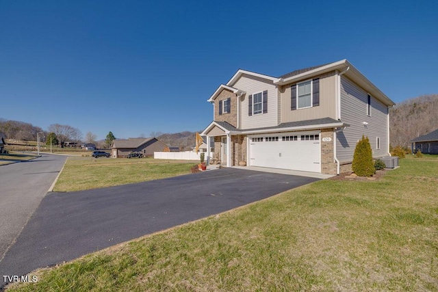 view of front of house with driveway, cooling unit, a front yard, an attached garage, and brick siding