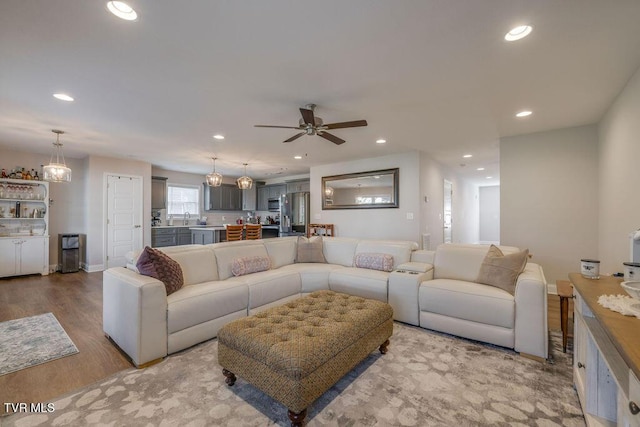 living area with recessed lighting, wood finished floors, baseboards, and ceiling fan