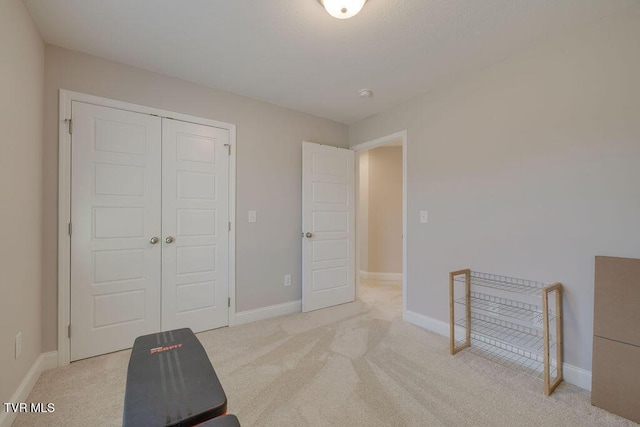 interior space with a closet and baseboards