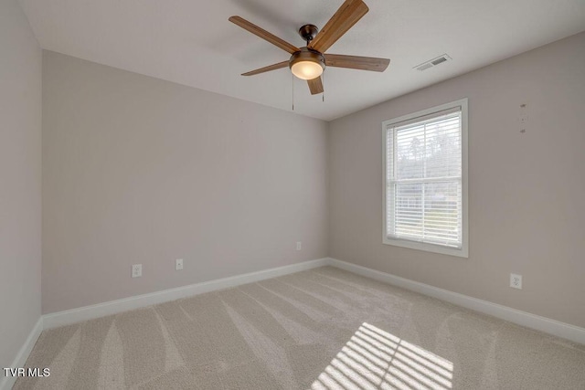 unfurnished room with visible vents, baseboards, carpet, and ceiling fan