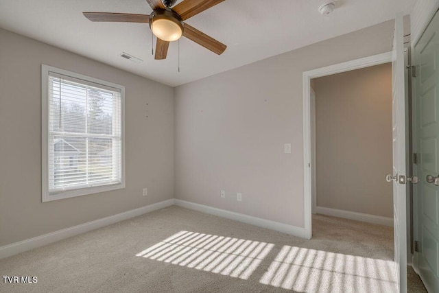 interior space with visible vents, a ceiling fan, and baseboards